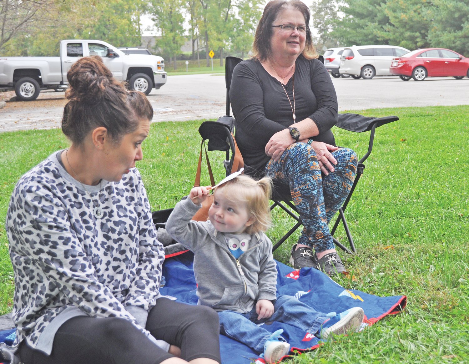 Josie Roberts, 2, plays an activity with mom Chelsea Roberts and grandma Debbie Carter at the Crawfordsville District Public Library’s Story Time at the Sugar Creek Trail on Wednesday. The library has placed two stories along the trail for families to read during October. Story Time, which is designed for children under 5, takes place at 10 a.m. Wednesdays on the trail. Another children’s program, Wiggle and Giggle, a music and movement activity, takes place at 10 a.m. Fridays at Pike Place. Both events are held weather-permitting and no registration is needed. The Elementary Explorers, a program for children in grades K-5, is held at 4 p.m. Tuesdays at the library pavilion, weather-permitting. Registration is required by calling 765-362-2242 ext. 2. The library’s Pumpkin Book Character Contest begins Oct. 24.